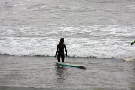 Lone Surfer carrying board along rugged Northern Oregon Coast