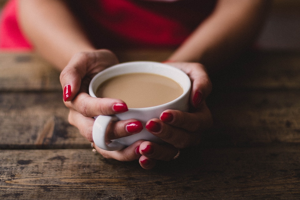 Woman Holding Coffee photo