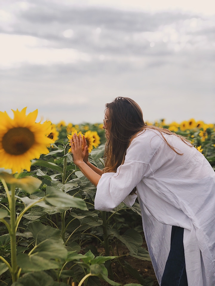 Woman Smelling Sunflowers photo