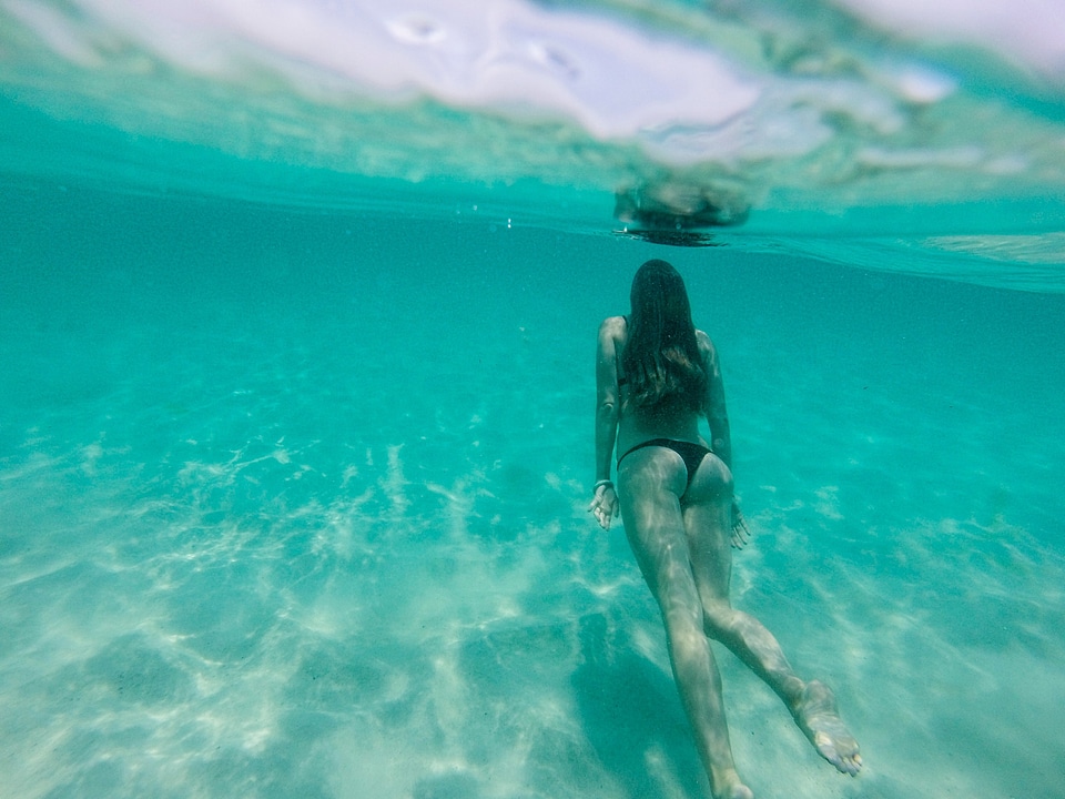 Woman Swimming Underwater photo