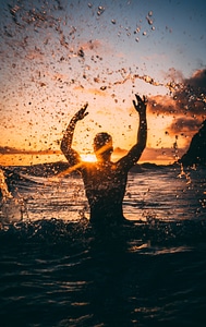 Man Splashing Water Sunset
