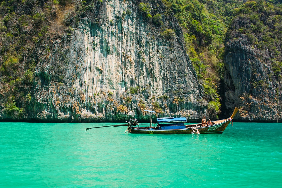Brown & Blue Boat Near Cliff