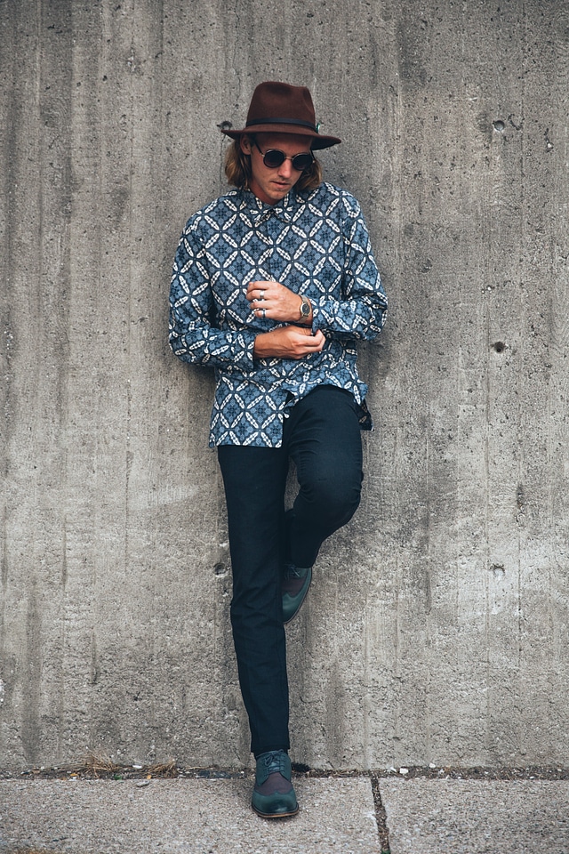 Young Man Leans On Wall