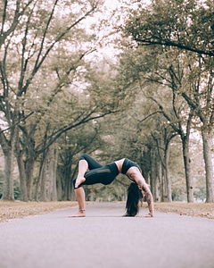 Woman Does Bridge Pose Yoga On Path photo