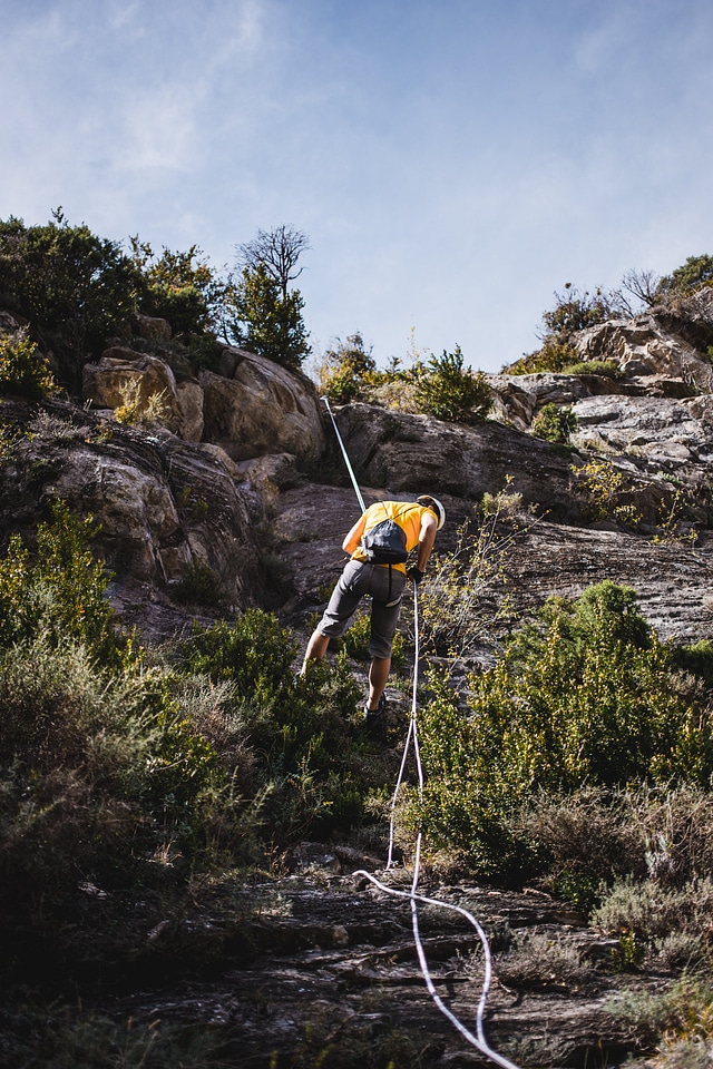 Repelling A Rock Face