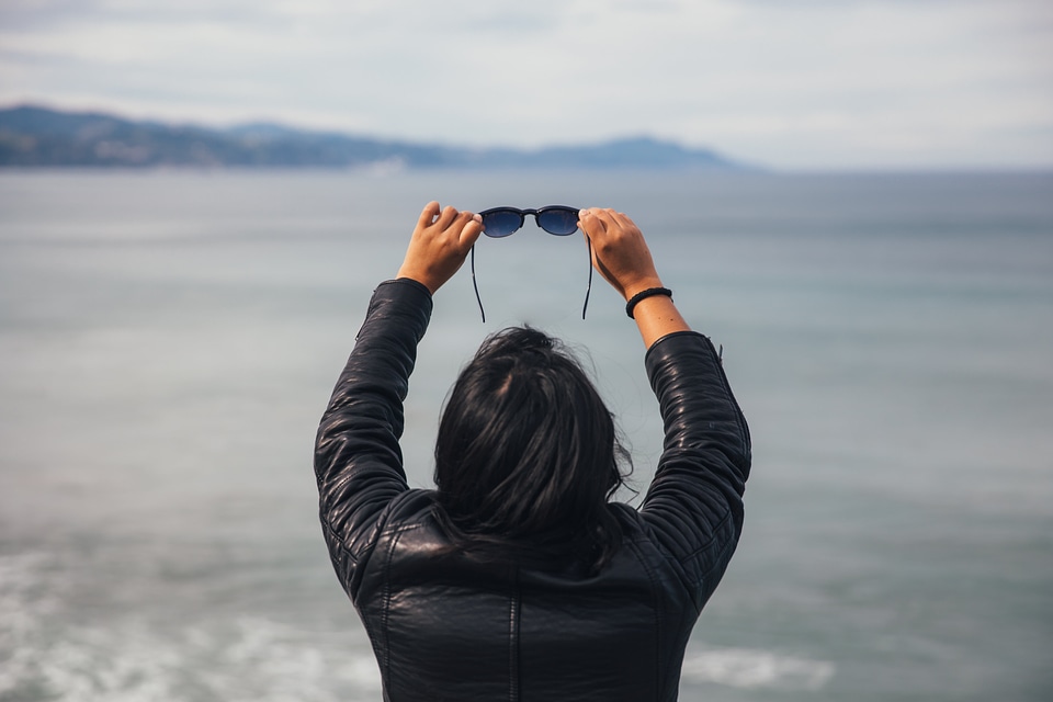 Woman Holding Sunglasses