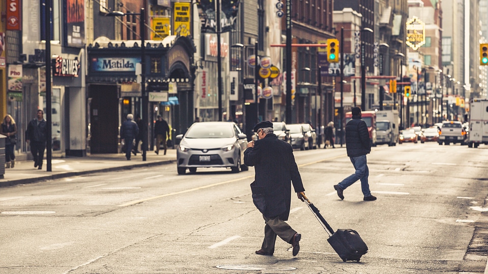Man Crossing City Street photo