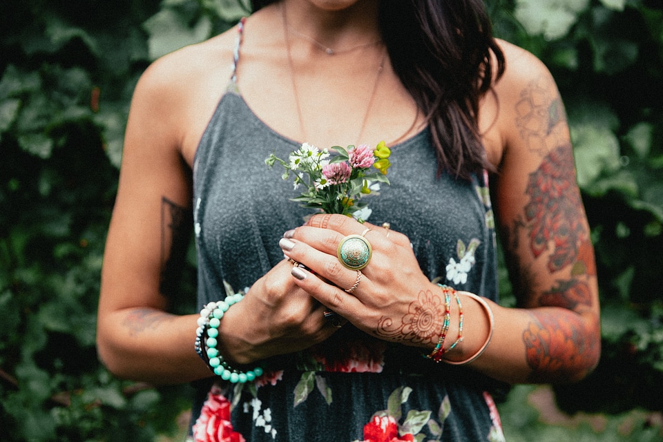 Women's Fashion Tattooed Woman Holding Flowers photo