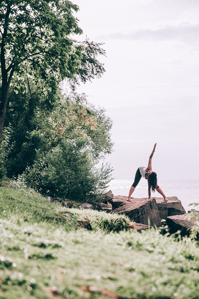 Woman Does Yoga Outdoors