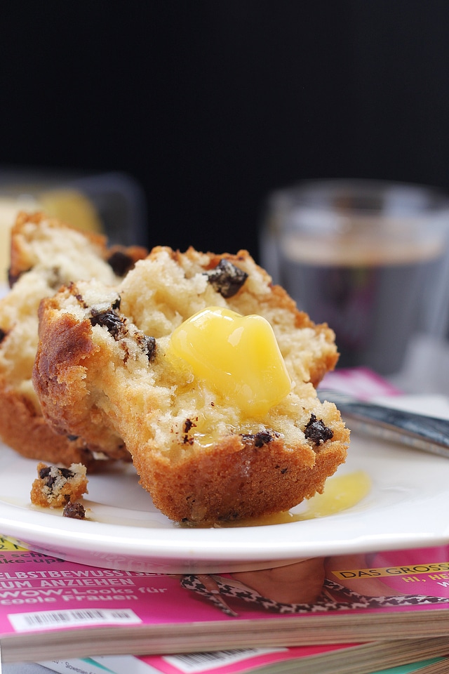 Butter Melting On Warm Muffin Over Coffee And Magazines photo