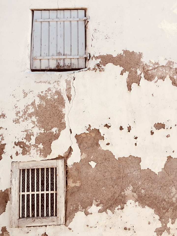 Rustic Windows And Shutters On Plaster Wall