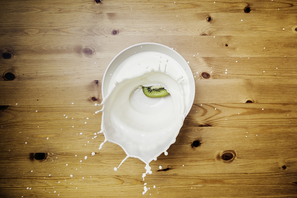 Milk Splash on Wooden Background