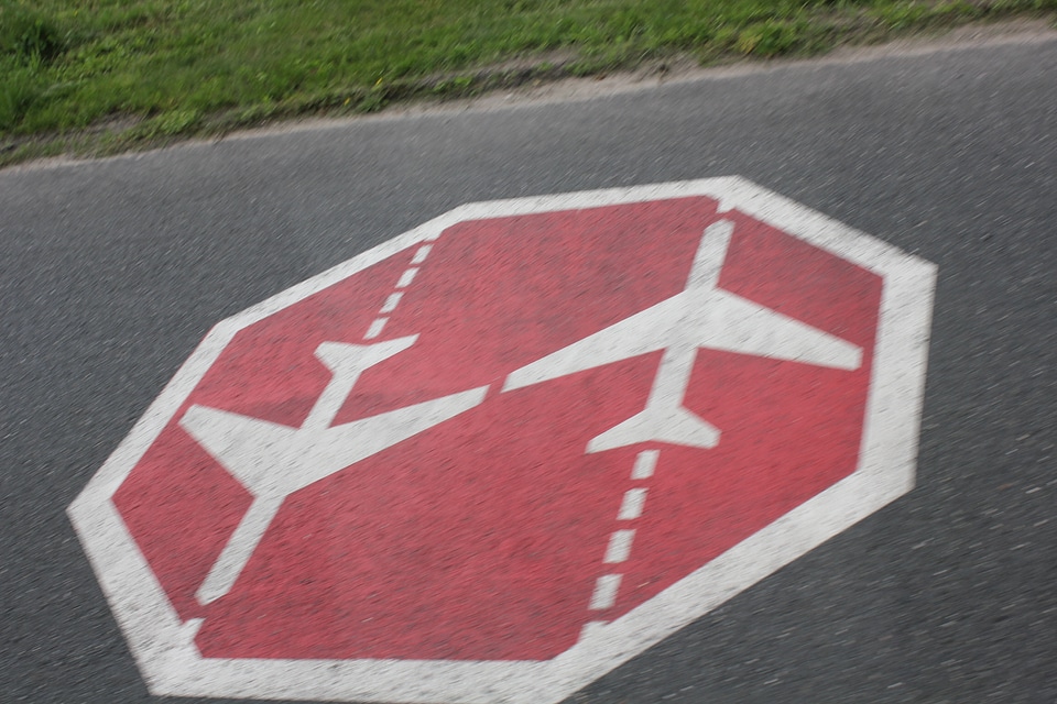 Beware of airplanes sign on the street