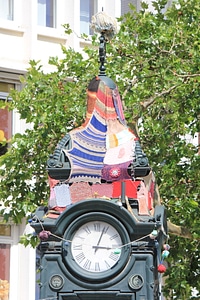 Guerilla knitting on old clock in Hannover photo