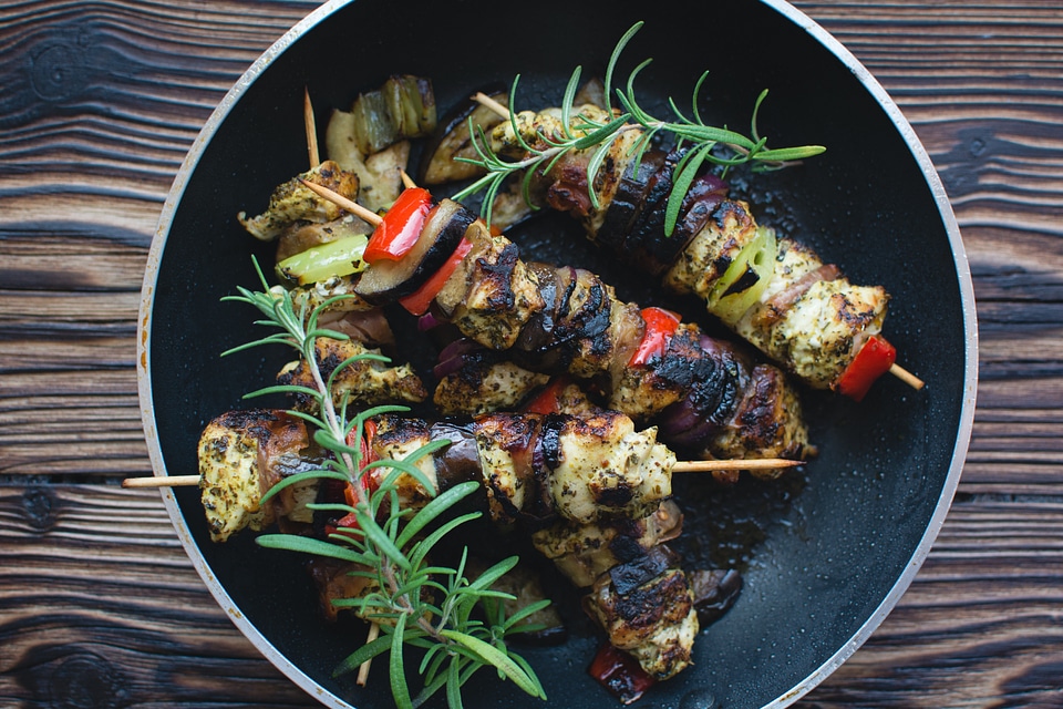 Chicken skewers on a wooden background
