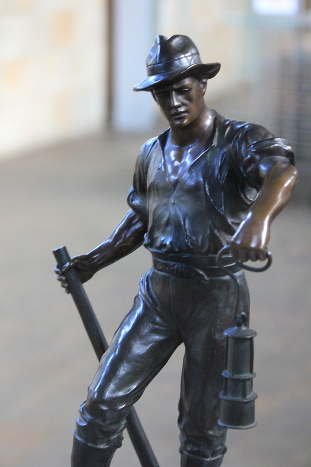 Bronze sculpture of a digger