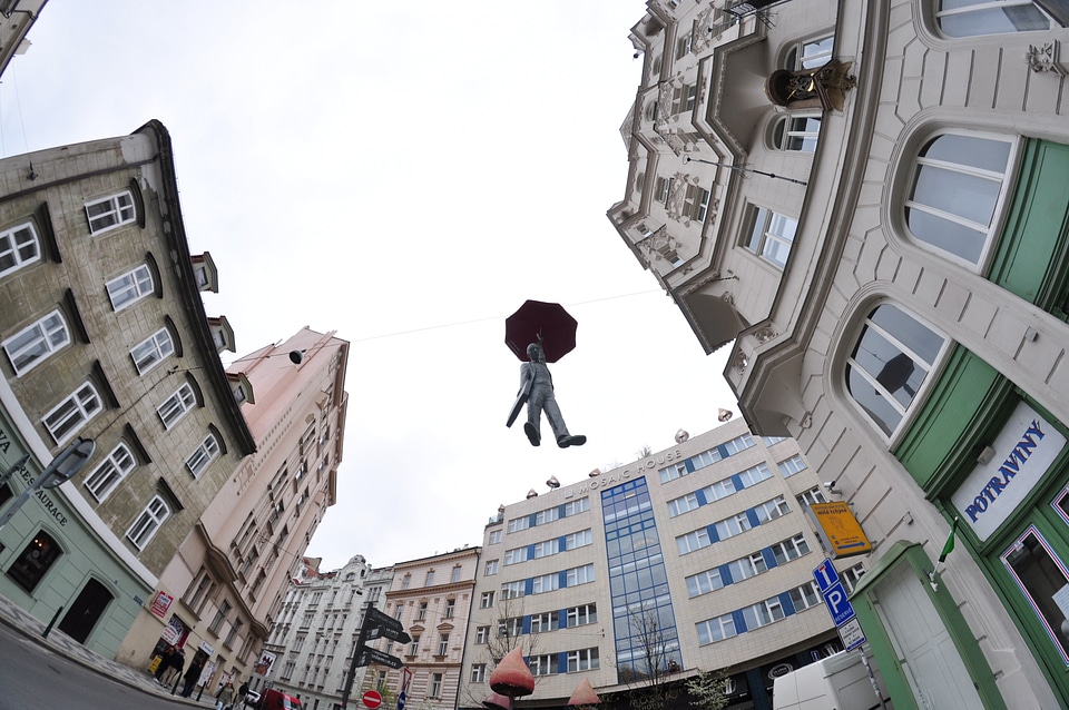 Flying statue of a man with umbrella in Prague