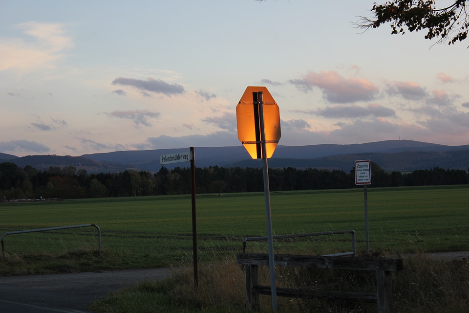 Golden sun reflecting on traffic sign