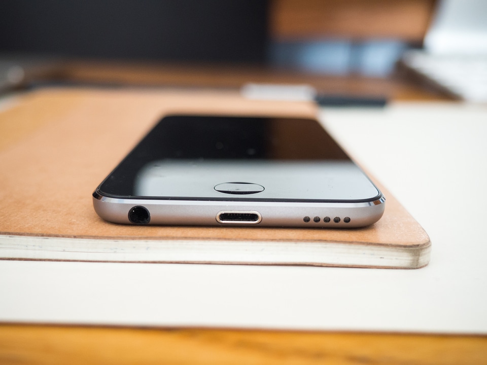 Phone and Sketchbook on Wooden Desk photo