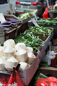 Stall with coconuts and vegetables in Chinatown NYC photo