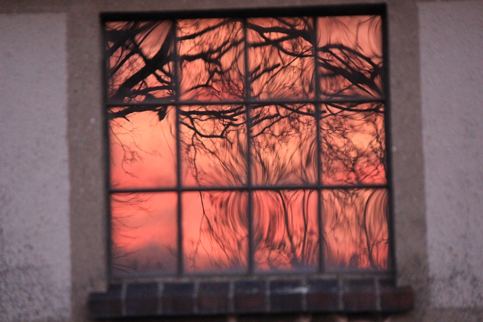 Sundown reflects in window