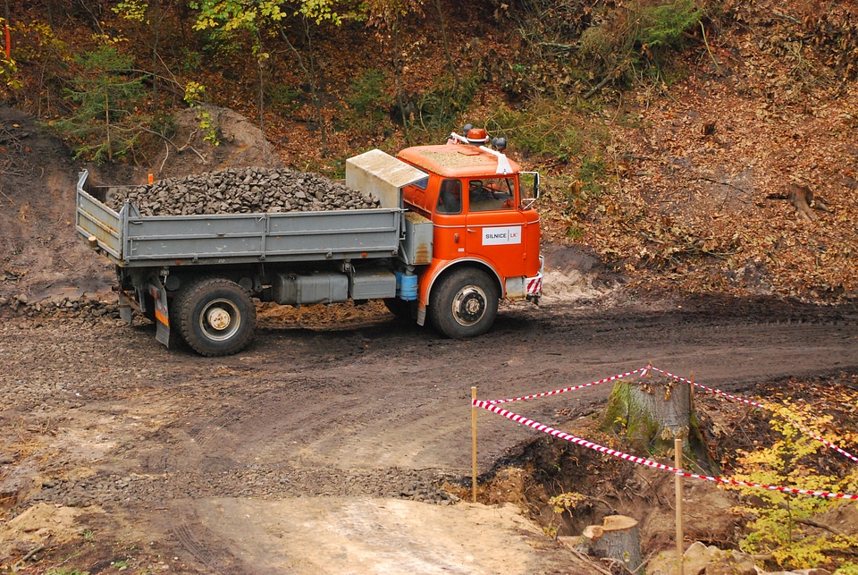 Orange flatbed truck in Czech woods
