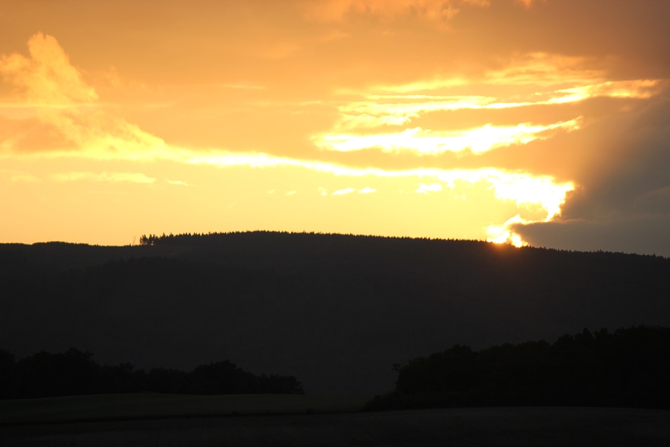 Burning sky behind mountain
