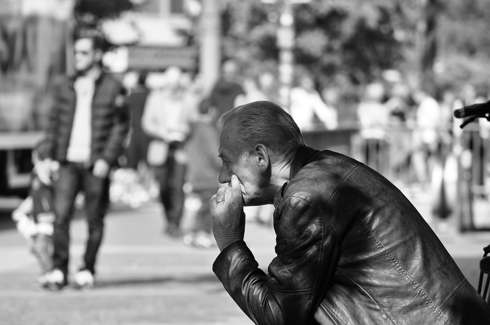 Old man smoking a cigarette in the streets