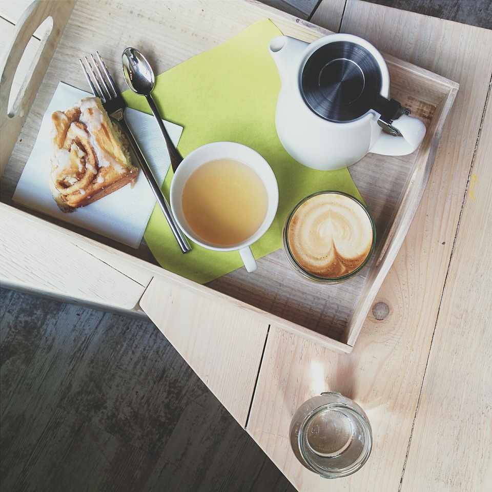 Cappuccino, tea and cinnamon roll