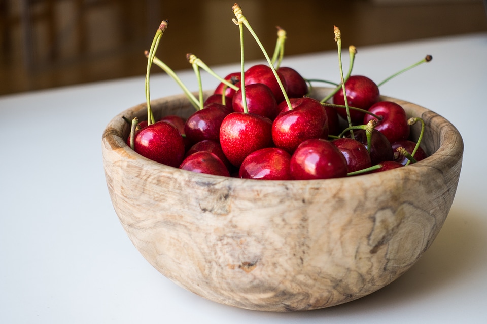 Fresh cherries in a wooden bowl