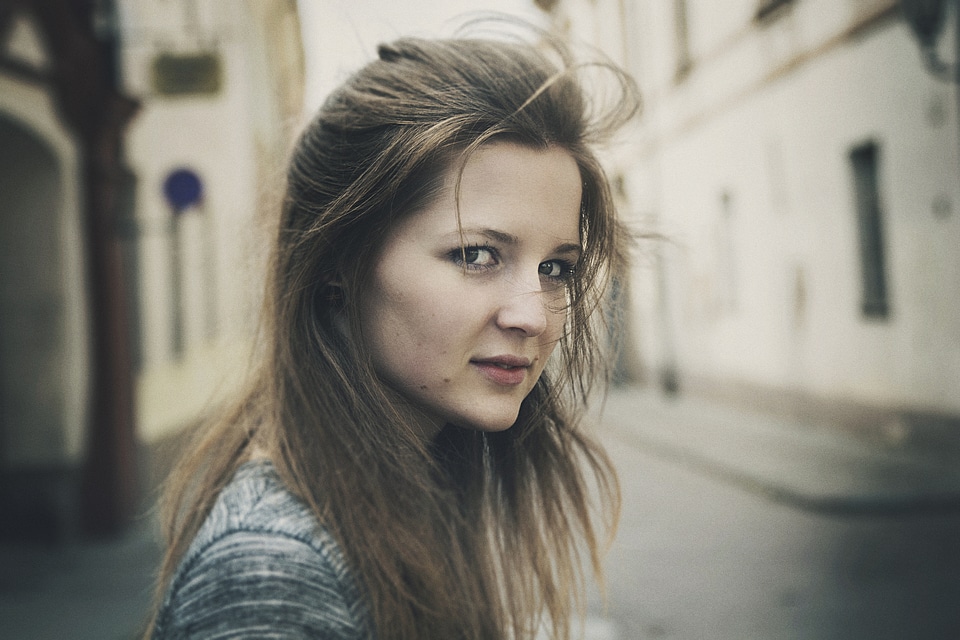 Side Portrait of Young Woman Standing Outside photo