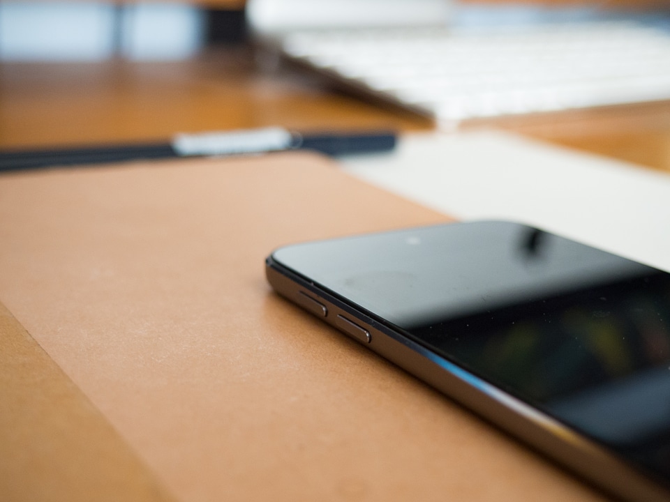 Phone and Notebook on Desk photo