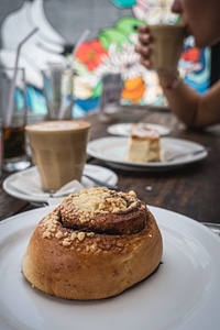 Cinnamon roll with coffee in a coffeeshop photo