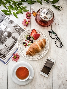 Breakfast Composition with Book, Croissant and Tea photo
