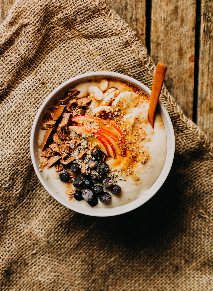 Banana oatmeal with blueberries, chocolate and apple