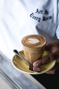 Barista holding a perfect flatwhite coffee