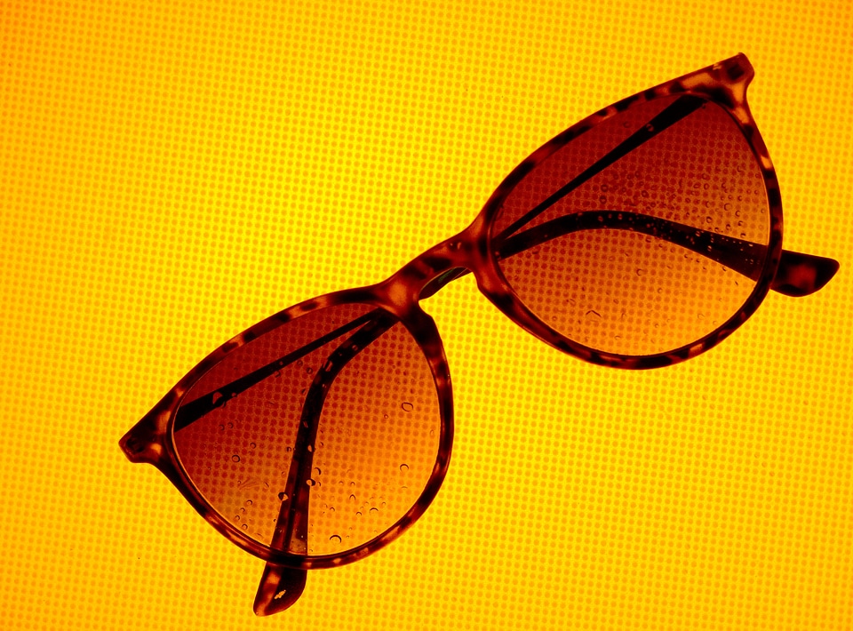 Sunglasses on Yellow Dotted Background