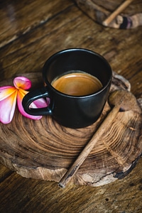 Small black cup with espresso coffee photo