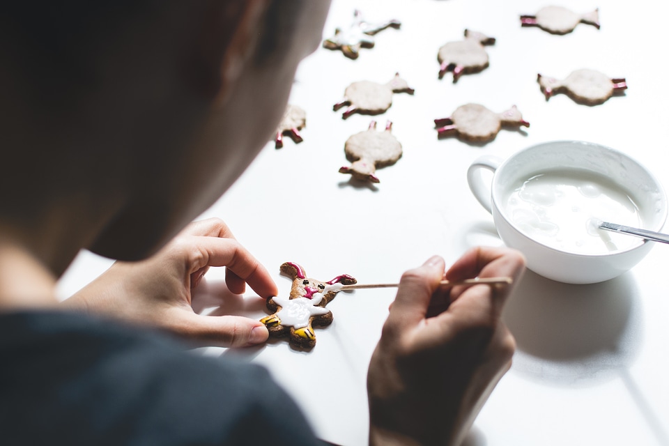 Girl decorating easter gingerbread cookies