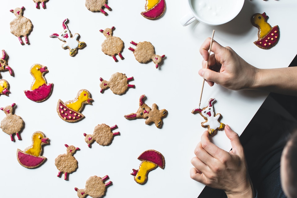Girl decorating easter gingerbread cookies