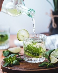 Pouring water in a glass with mint and lime photo