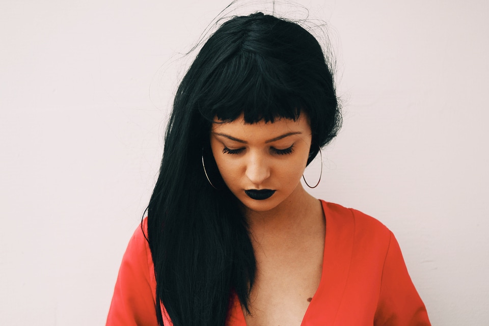 Black Haired Woman with Bangs and Lowered Head