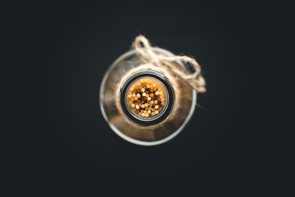 Spaghetti in an empty olive oil glass bottle