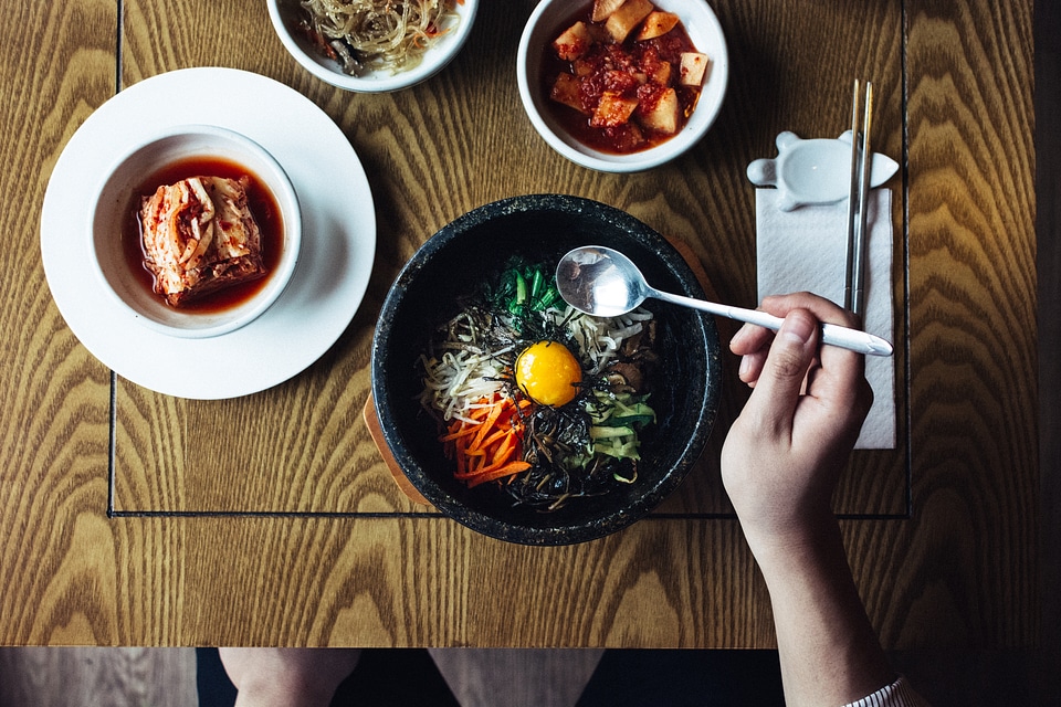 Eating Korean bibimbap and kimchi