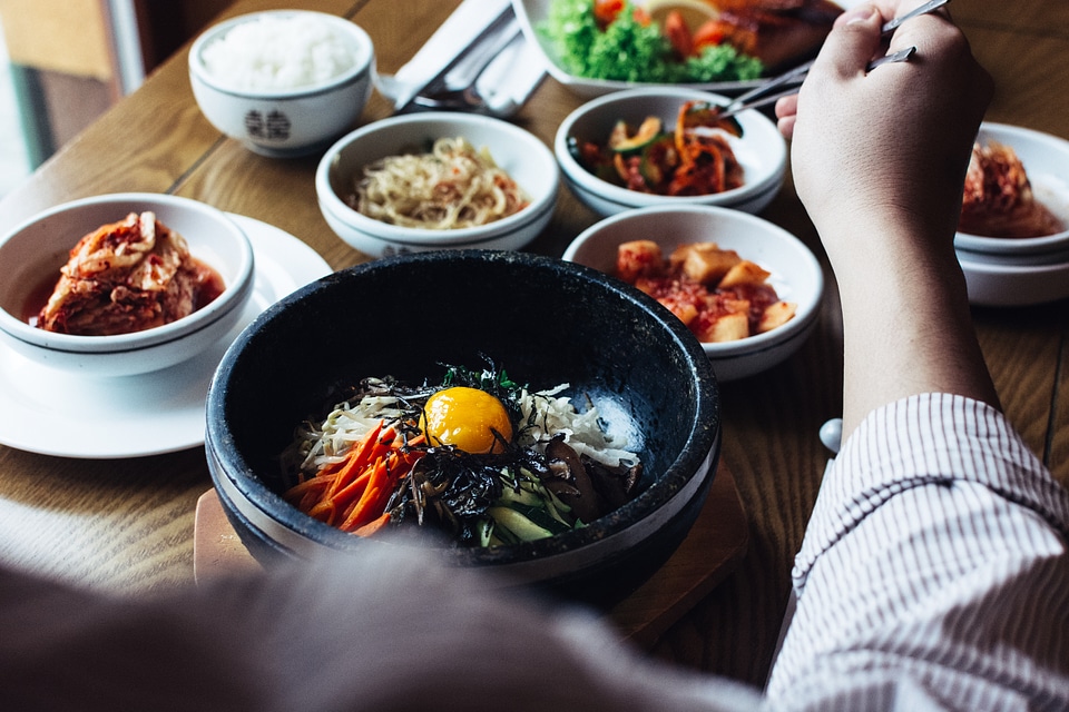 Eating Korean Bibimbap with chopsticks