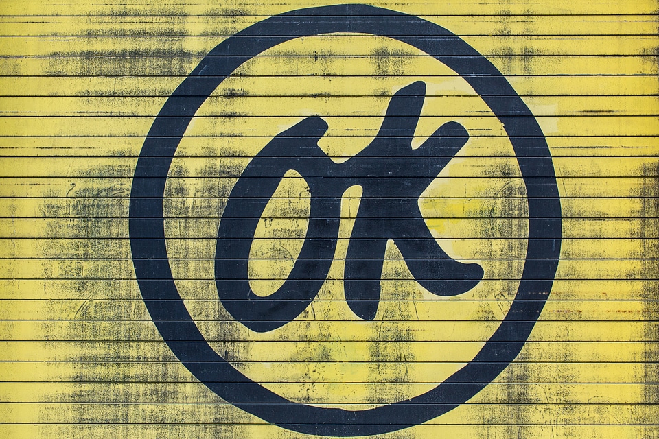 Ok Inscription on Yellow Grunge Wall