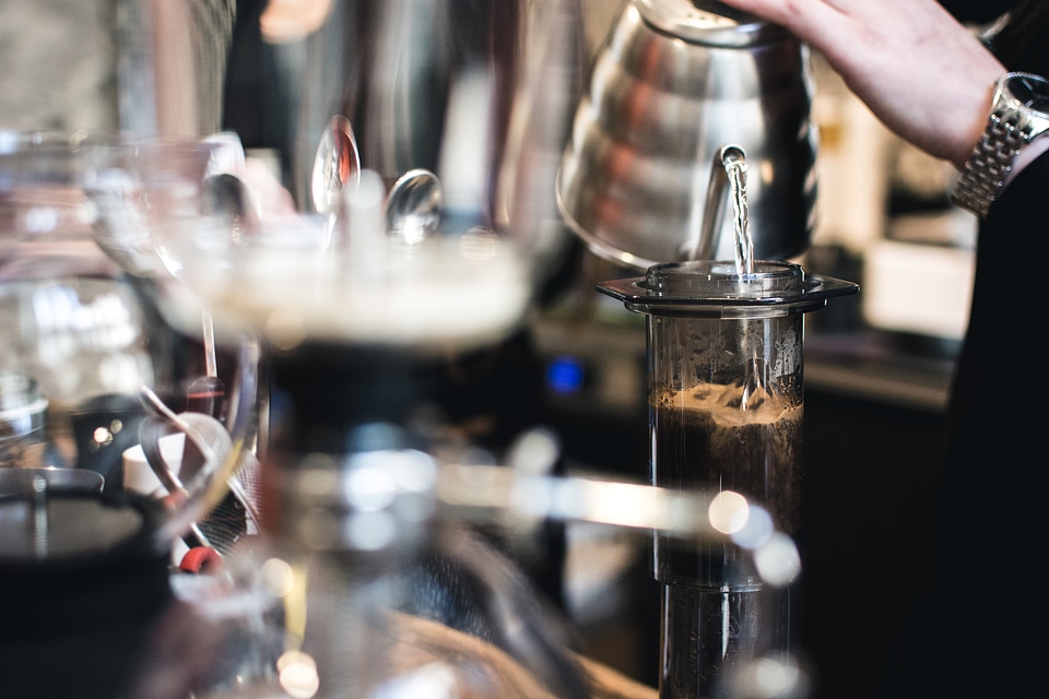 Pouring water in Aeropress filter coffee photo