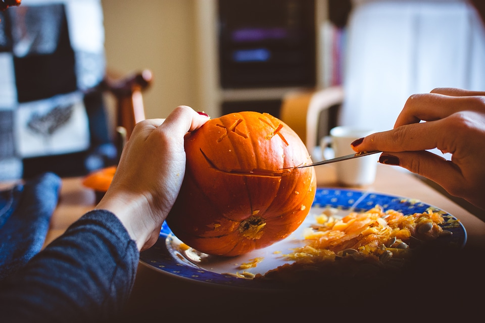 Carving Halloween pumpkin