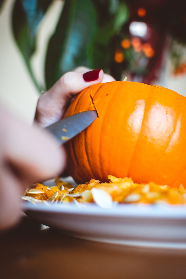 Carving Halloween pumpkin