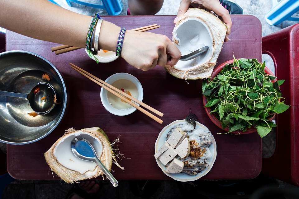 Eating coconut in a Vietnamese street food market